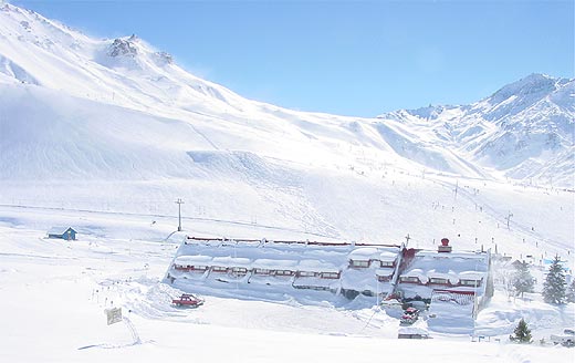 Escorpio Hotel with ski resort in background.